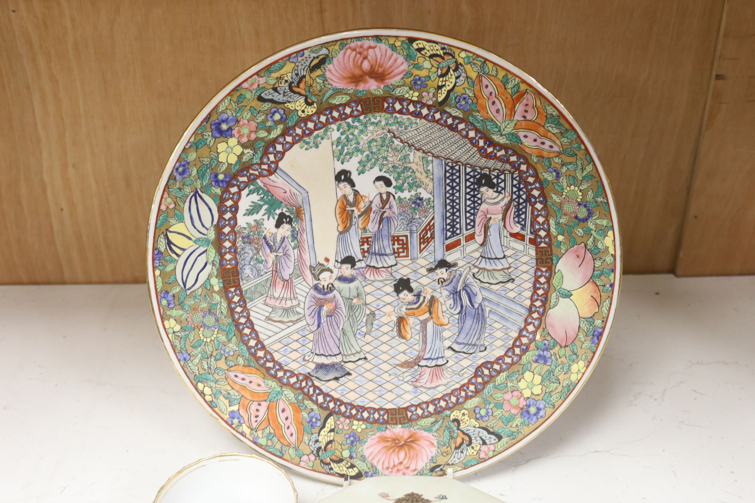 Seven 18th century English porcelain tea bowls, an armorial box and cover and a famille rose dish, diameter 30cm